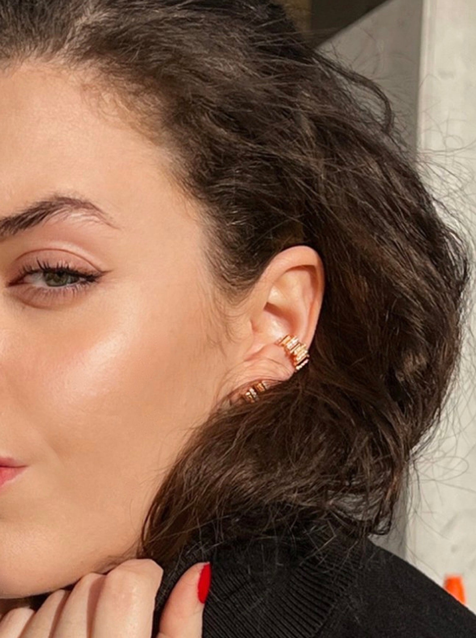 Rose Gold and diamond earcuffs and earrings from the Lavertue collection by DE MONT Fine Jewelry, worn in natural light by a model with green eyes and brown hair.
