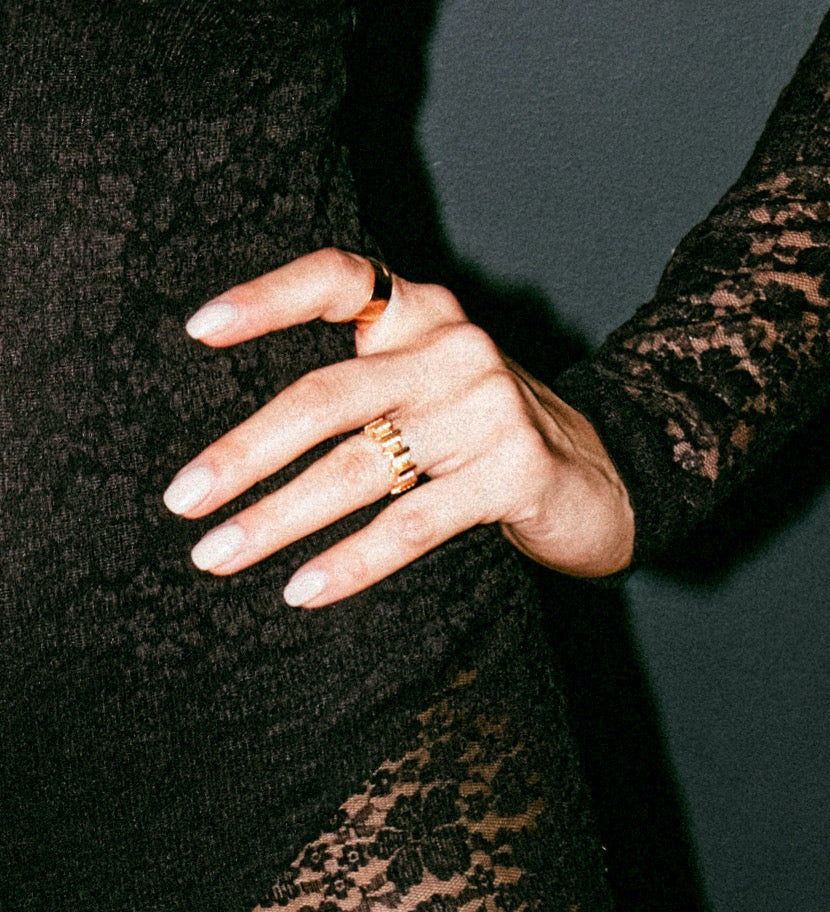 Close up of LAVERTUE and MEET IN THE MIDDLE fine ring worn on a feminine hand model, inspired by a timeless fable about patience and healing. Designed in Montreal, available in solid rose gold and 24k vermeil, with zircon or diamond stones.