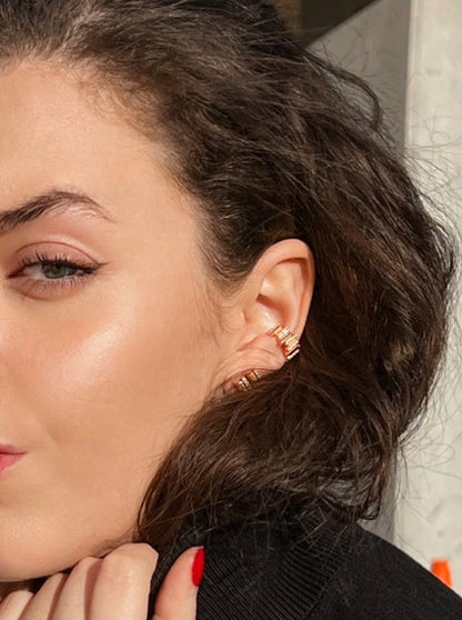 Rose Gold and diamond earcuffs and earrings from the Lavertue collection by DE MONT Fine Jewelry, worn in natural light by a model with green eyes and brown hair.