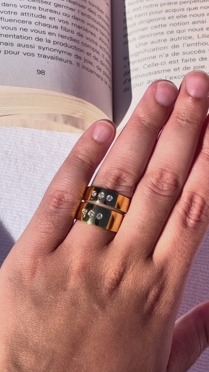 close up video of DOLCE rings worn by a hand model reading a book in montreal by the pool in summer.